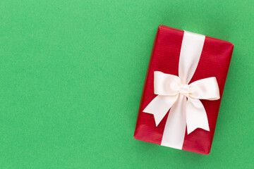 Christmas gift boxes with ribbons on color tabletop.