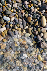 clear sea water on a rocky beach. selective focus. verti cal photo
