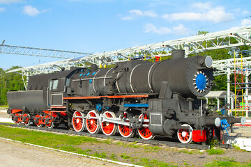Fototapeta na wymiar old steam locomotive at the station in the summer