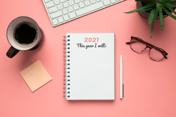Stock photo of 2021 new year notebook ready to write goals in it, on a pink background