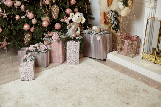 Christmas Gift Box Under Chrismas Tree Lies On White Carpet Near Fireplace