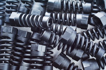 Black plastic and rubber parts of automotive manufacturing by high precision mold injection in the industrial factory. Spare part background texture.