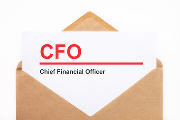 A white sheet with the text cfo lies in an open craft envelope on a white background with copy space. Business concept image