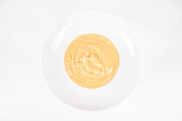 Pumpkin soup on a plate on a white background