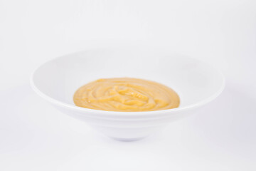 Pumpkin soup on a plate on a white background