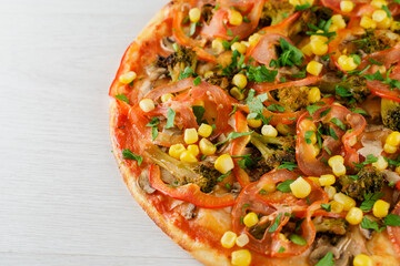 Pizza close-up on white wooden background. Food delivery for people who stay at home. Tasty fast food at quarantine coronavirus covid-19 period.