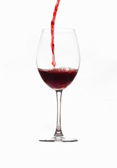Filling a glass of red wine into a thin, clear crystal goblet