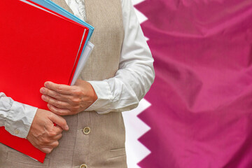 Woman holding red folder on Qatar flag background. Education and jurisprudence concept in Qatar