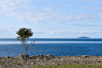 Coastal view at the island Bla Jungfrun in the horizon