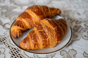 Two fresh baked puff croissants, traditional French breakfast