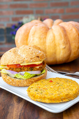 Making fresh and healthy vegetarian hamburgers with grilled pumpkin burgers, organic buns and vegetables