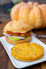 Making fresh and healthy vegetarian hamburgers with grilled pumpkin burgers, organic buns and vegetables