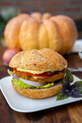 Making fresh and healthy vegetarian hamburgers with grilled pumpkin burgers, organic buns and vegetables
