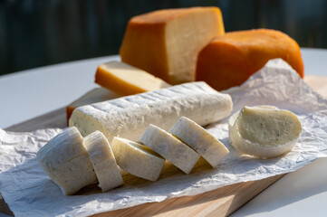 Cheese collection, Belgian abbey cheeses made with brown trappist beer and fine herbs and view on Maas river in Dinant, Wallonia, Belgium