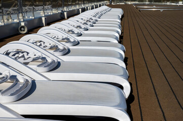 Fototapeta premium Cruise ship sun deck with line of lounge chairs