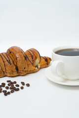 Top view or flat lay of coffee cup and croissant on white background with copy space.
