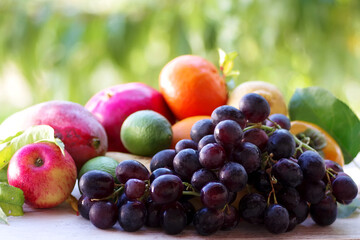bunch of grapes and variety fruits on table