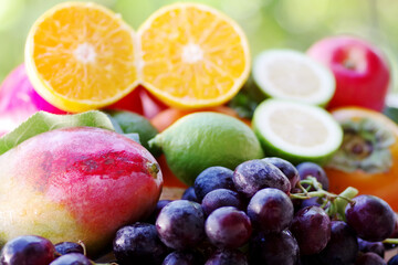 Naklejka na ściany i meble grapes, mangoes, limes and sliced citric fruits