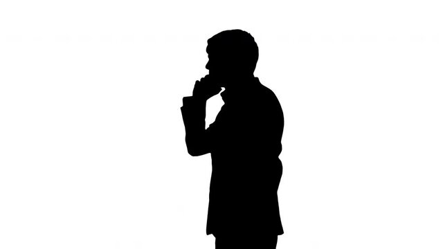 Silhouette Stressed and angry businessman talking on the phone.