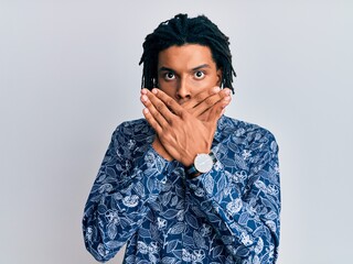 Young african american man wearing 80s style shirt shocked covering mouth with hands for mistake. secret concept.