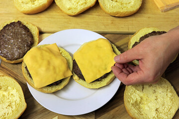 Adding a cheese slice to make a cheeseburger