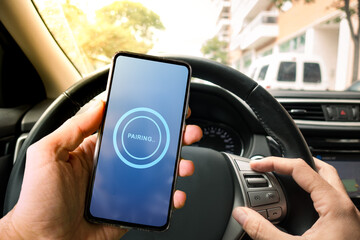 Pairing Smartphone with Car Multimedia Audio System. Using Mobile Phone Device While Driving. Hands Free Talking and Listening Online Music While Traveling by Car. - obrazy, fototapety, plakaty
