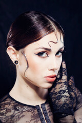 Woman beauty makeup on black background black widow concept
