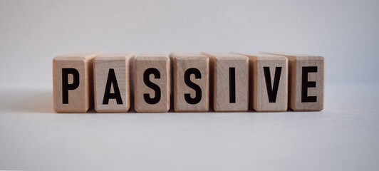word PASSIVE, inscription on wooden cubes on white background