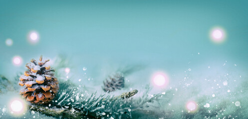 Fototapeta na wymiar Winter Christmas background with magic lights, pine cone in snow landscape
