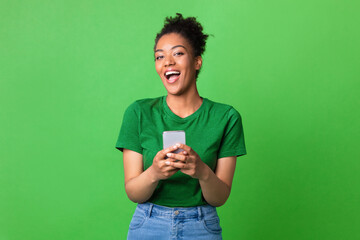 Portrait of excited black woman using her mobile phone
