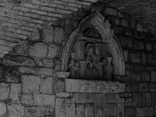 Fragment of an old brick wall with a stucco pattern