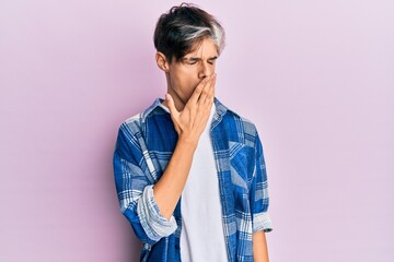 Young hispanic man wearing casual clothes bored yawning tired covering mouth with hand. restless and sleepiness.