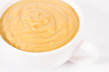 Pumpkin soup in a bowl on a white background