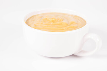 Pumpkin soup in a bowl on a white background