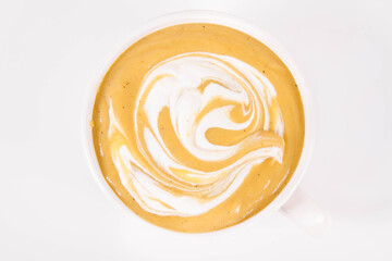 Pumpkin soup decorated with cream in a bowl on a white background