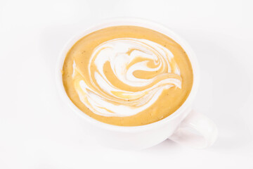 Pumpkin soup decorated with cream in a bowl on a white background