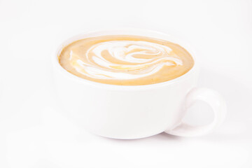 Pumpkin soup decorated with cream in a bowl on a white background