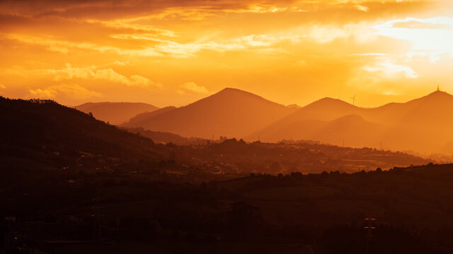 Orange Sunset In The Mountains With Clouds