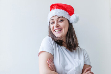 Beautiful girl in red Santa Claus hat isolated on white background. Winter portrait of young woman. Happy Christmas and New Year holidays concept.