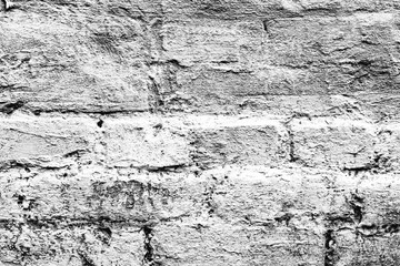 Texture of a brick wall with cracks and scratches which can be used as a background