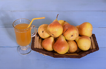 Pears on the table and a glass of pear juice.