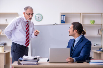 Two employees in the office in business presentation concept