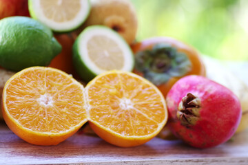 slices of orange, lemons and pomegranate on table