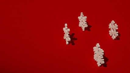 wooden snowflakes on red background with hard lighting