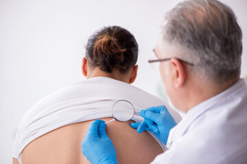 Young man visiting experienced doctor dermatologist