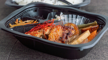Grilled chicken with perfect brown color inside a japanese style lunch box