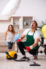 Young male contractor cleaning the house with his small daughter