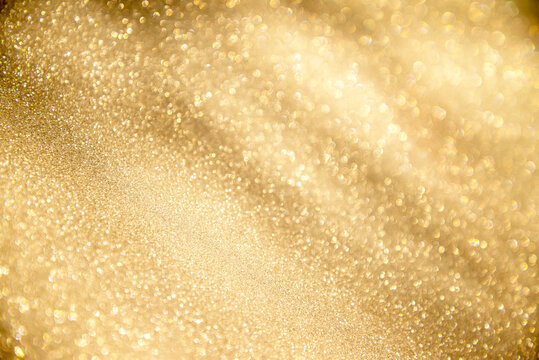 abstract defocused lights, sparkling holiday bokeh background with golden tones, elegant christmas backdrop