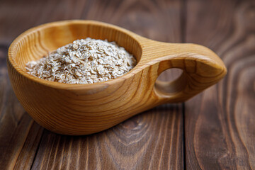 Wooden Cup with oatmeal. Health food. Wood texture