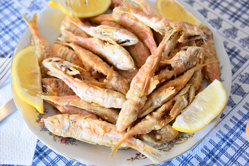 Fried Anchovies in the Plate With lemons